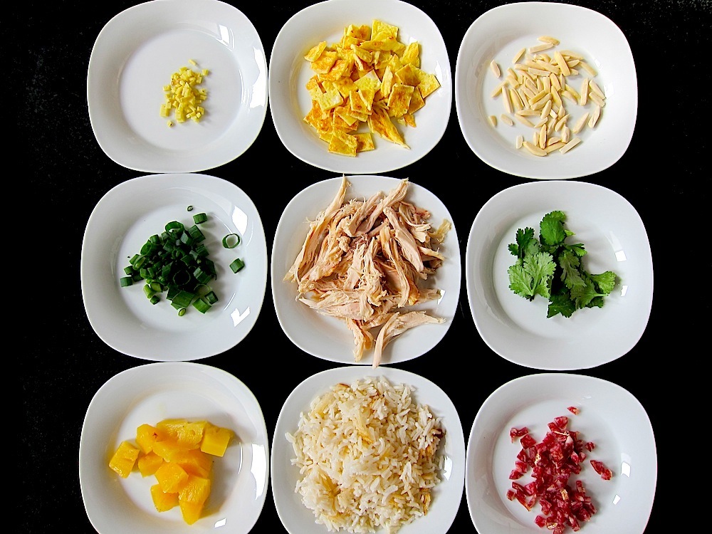 Arroz Chaufa ingredients: ginger, egg, almonds, scallions, chicken, cilantro, pineapple, rice, salami.
